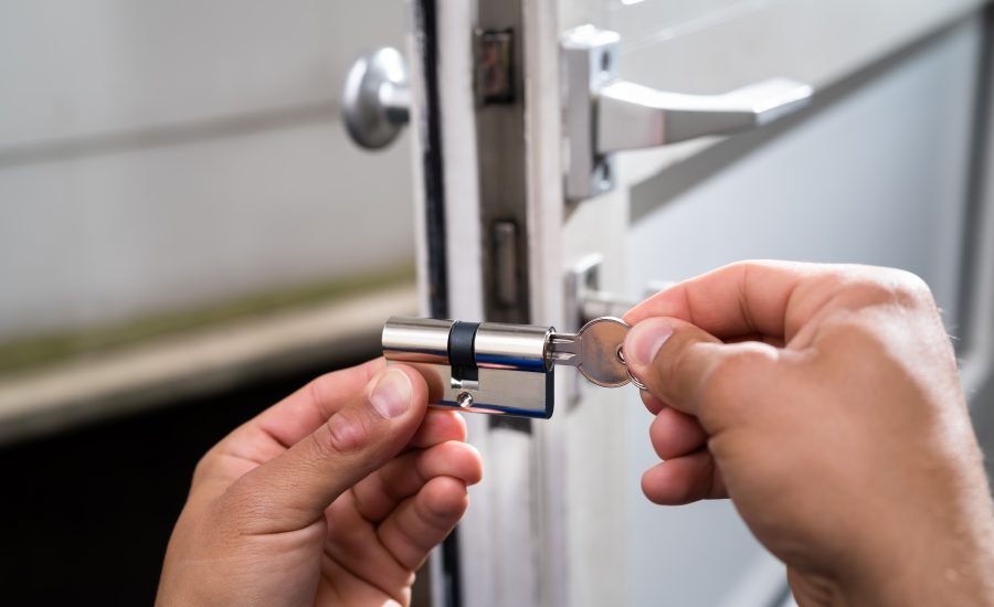 Professional locksmith opening a safe without keys using specialized tools