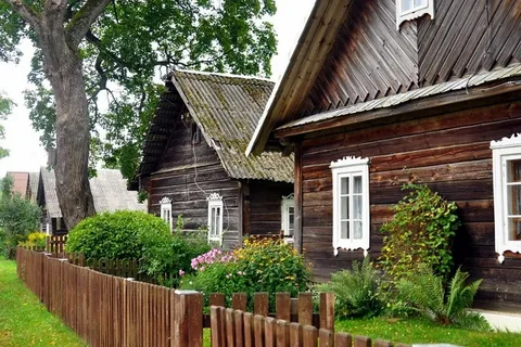 Traditional Lithuanian sodziu village with wooden homes and open fields